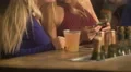 Glamorous blonde ladies watching video on smartphone, having fun at party in bar 4k or 4k+ Resolution