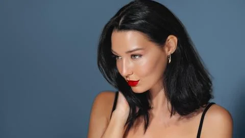 Glamorous Model With Red Lips and Gold Jewelry on Blue Background Stock Photos