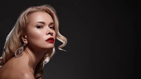 Glamorous Studio Portrait Showcasing Bold Red Lips And Sparkling Earrings, Soft Stock Photos