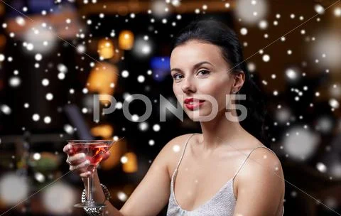 Glamorous woman with cocktail at night club or bar Stock Photos