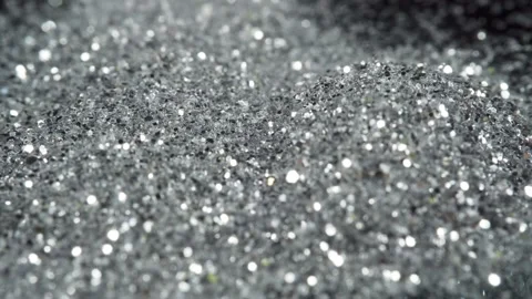 Glamour shine confetti falling down. Silver sequins fall on the black floor Stock Footage 164076589