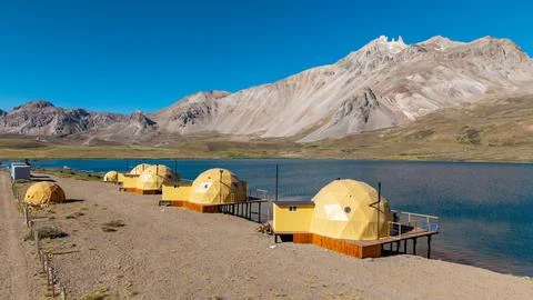 Glamping on a lagoon surrounded by mountains. Stock Photos