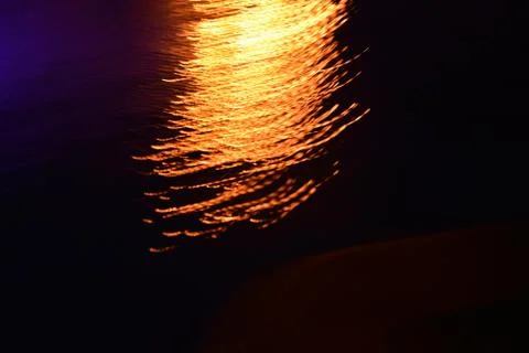 Glare and reflection of light on the water. Stock Photos