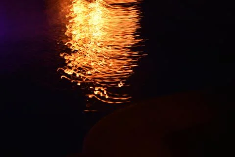 Glare and reflection of light on the water. Stock Photos