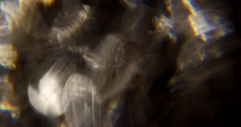 Glare of light in the lens on a black background Video stock 286869659