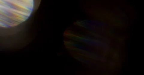 Glare of light in the lens on a black background Video stock 286870261