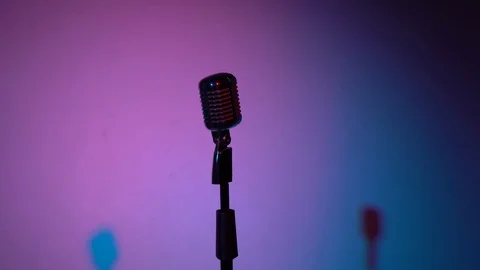 Glare microphone for record or speak to audience on stage in dark empty room. Stock Footage 118527815