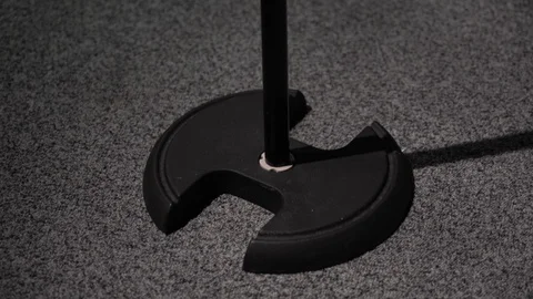 Glare microphone on stage on black background close up. White spotlights shine. Stock Footage 118544157