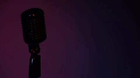 Glare microphone on stage on dark background. Colors of spotlights change. Video stock 118527863