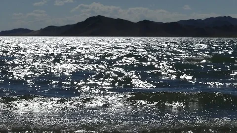 The  glare of the sun and the waves, slow motion. Stock Footage 79130853