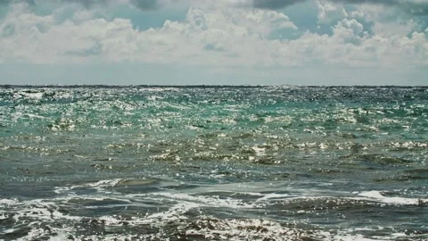 The glare of the sun on the sea waves. Sky with clouds in the background. Long Stock Footage 218405670