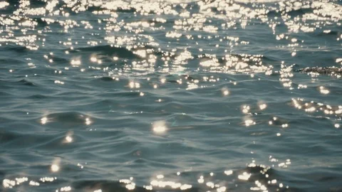 Glare of sunlight on the water surface. Reflection of light on the sea waves. Stock Footage