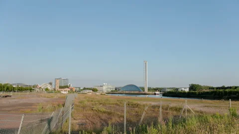 Glasgow Science Centre and Tower across wasteland and River Clyde Stock Footage 139836324