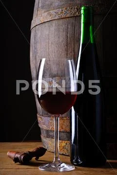Glass and bottle of red wine Stock Photos