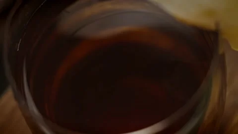 A glass of appetizing apple juice. 4k macro video in slow motion Stock Footage 159970765