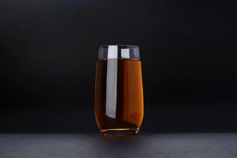 Glass of apple and grape juice on black background Stock Photos