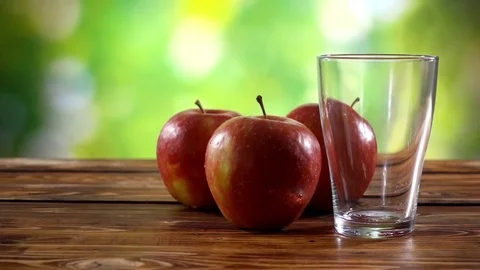 Glass with apple juice on the table. Stock Footage 82865524