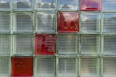 Glass background (backdrop) with square texture and four red squares. Stock Photos