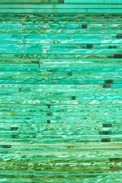 Glass background with stripe pattern in hue of green color. Stock Photos