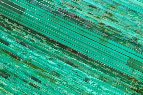 Glass background with stripe pattern in hue of green color. Stock Photos
