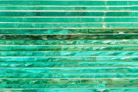 Glass background with stripe pattern in hue of green color. Stock Photos