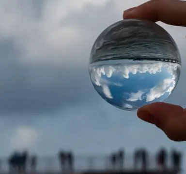 Glass Ball and cloudy reflection Stock Photos