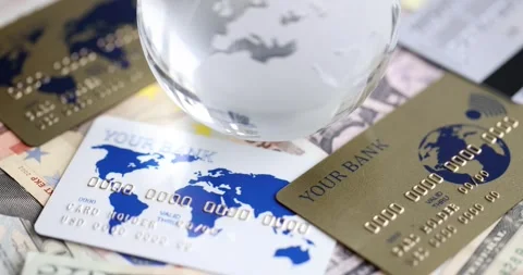 Glass ball with map of earth lying on bank cards on dollar bills closeup 4k Stock Footage 274831957