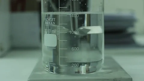 Glass beaker detail adding dye Stock Footage 77046234