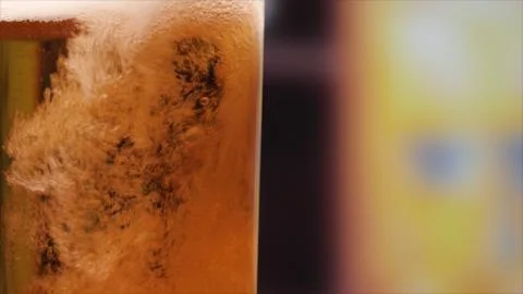 A glass of beer is on the bar. Stock Photos