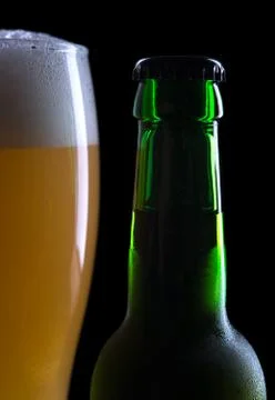 Glass of beer with bottle Stock Photos