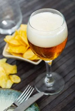 Glass of beer with chips for snack Stock Photos
