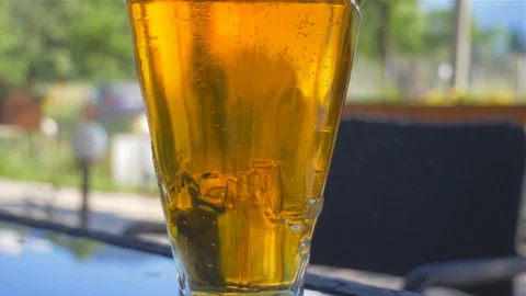 A glass of beer close up in a park Stock Footage 112108422