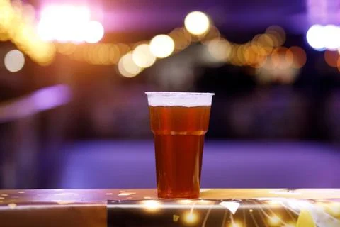 Glass of beer on concert lights background. Stock Photos