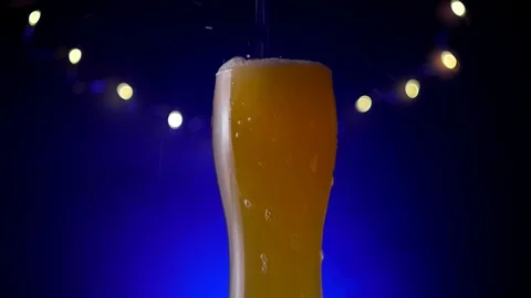Glass of beer on dark background Stock Footage 129571280