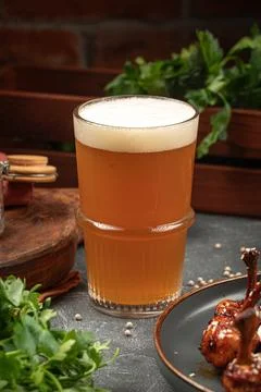 Glass of beer on grey table Stock Photos