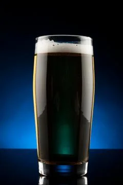 Glass of beer with reflection Stock Photos