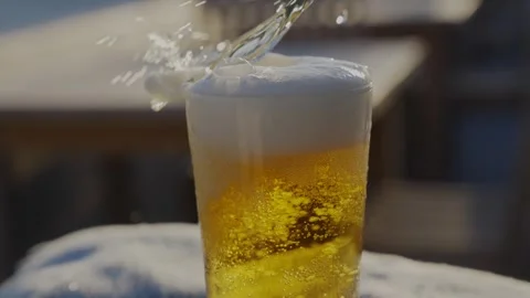 A glass of beer is sitting on a table Stock Footage 306575907