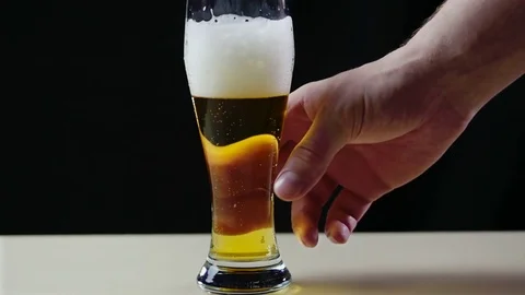 Glass with beer slow moving bubbles 4K frames - Bubbles and foam quickly move in Stock Footage 77925789