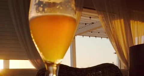A glass of beer in the sunset rays Stock Footage 227011748