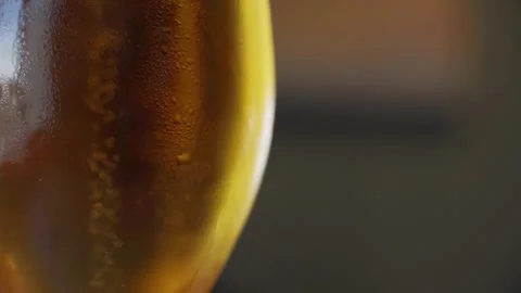  A glass of beer is on the table and foaming. Close up shot. Stock Footage 245441869