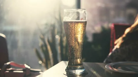 A glass of beer on the table in the bar. Bubbles. Stock Footage 90312396