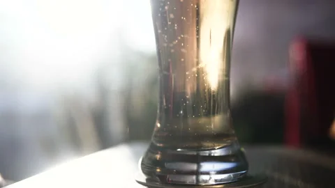 A glass of beer on the table in the bar. Bubbles. Stock Footage 90312846