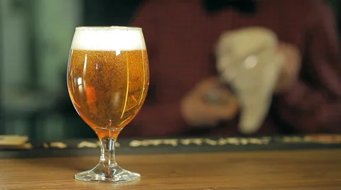 A glass of beer on the table Stock Footage 62997717