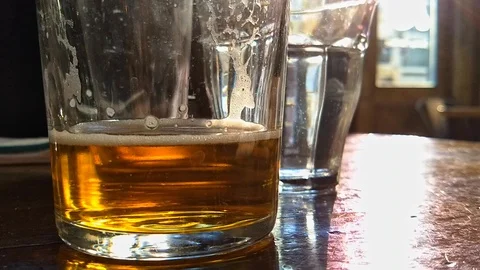 Glass of Beer on Table Stock Footage 107782459