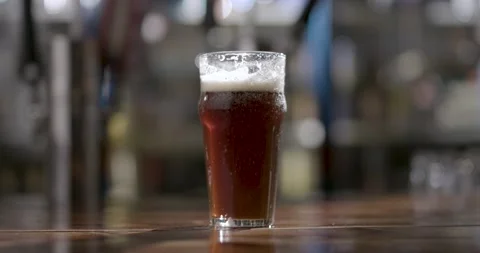 A glass of beer on a table Stock Footage 155450326