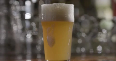 A glass of beer on a table Stock Footage 155453661