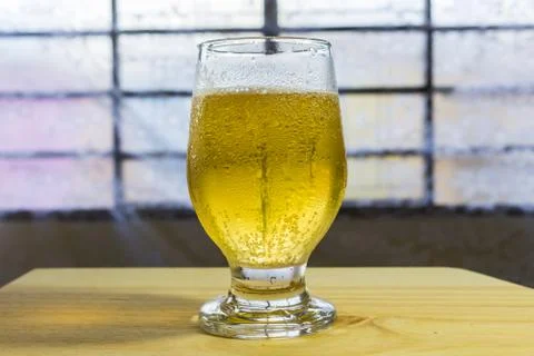 Glass of beer on a table. Stock Photos