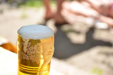 A glass of beer on the table.	 Stock Photos