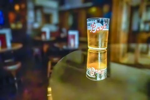 A glass of beer on the table. Stock Photos