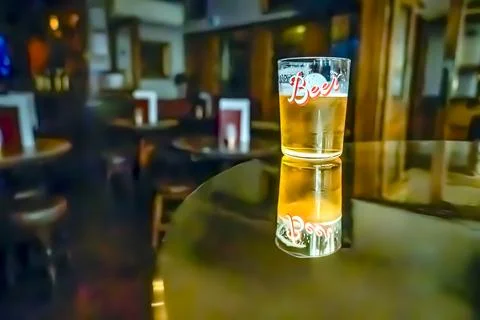 A glass of beer on the table. Stock Photos